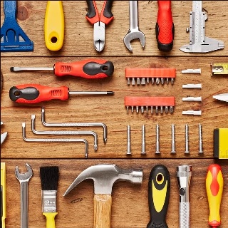 A photograph of a panel of hardware tools, including a hammer, carious screwdrivers, etc.